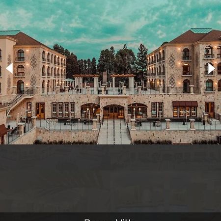 Buona Vitta Gramado Resort & Spa By Gramado Parks エクステリア 写真 The photo shows a spacious and elegant building design, likely a hotel or resort. The structure features multiple stories and large windows, with outdoor seating areas visible on a terrace or patio. The exterior has a combination of stone and modern 